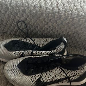 Knitted pearl colored Nike tennis shoes